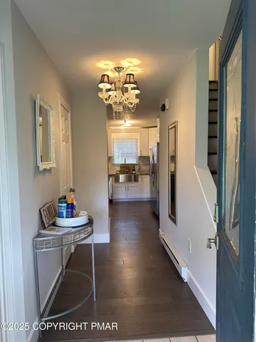 a dining room with furniture and a chandelier