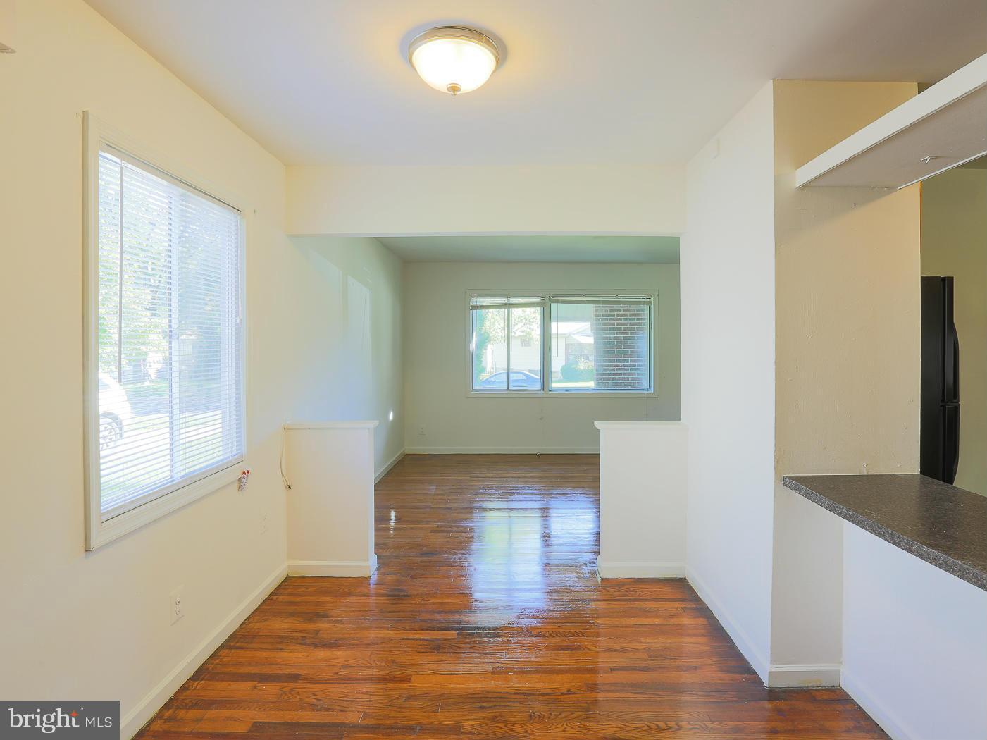 3114 Fairview Road Baltimore, MD 21207 - Photo 13 of 30 a view of empty room with wooden floor and fan