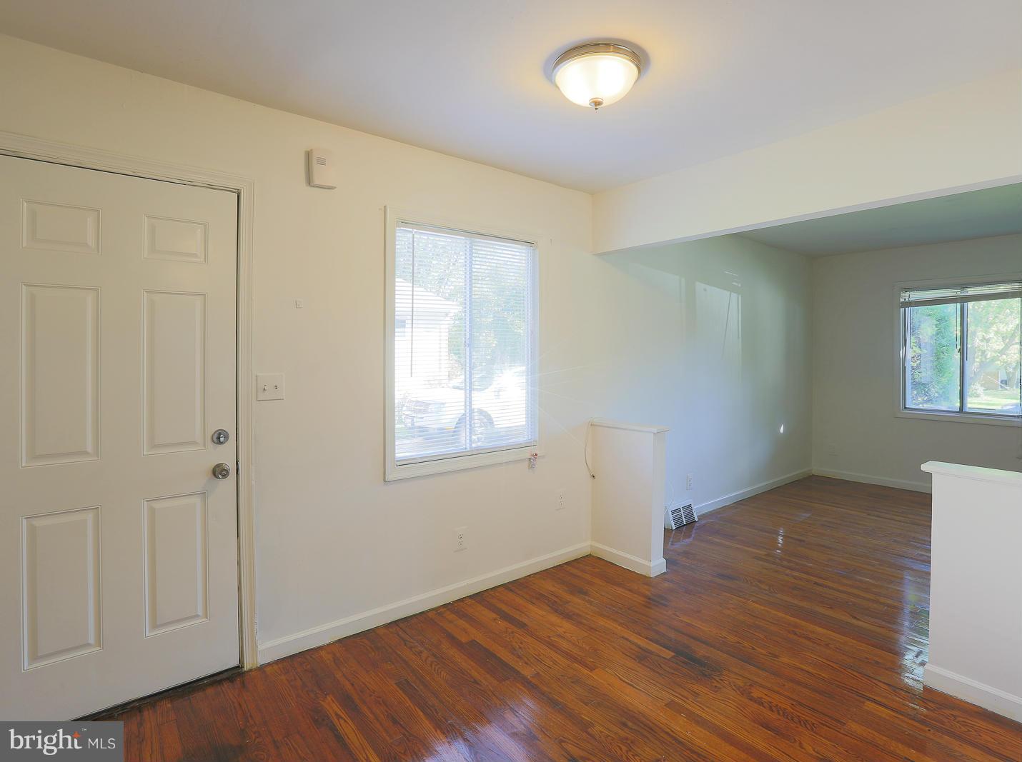 3114 Fairview Road Baltimore, MD 21207 - Photo 14 of 30 an empty room with wooden floor and windows
