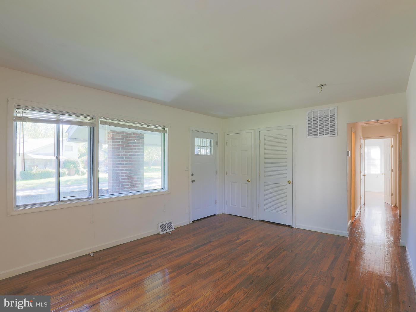 3114 Fairview Road Baltimore, MD 21207 - Photo 17 of 30 a view of empty room with wooden floor and fan