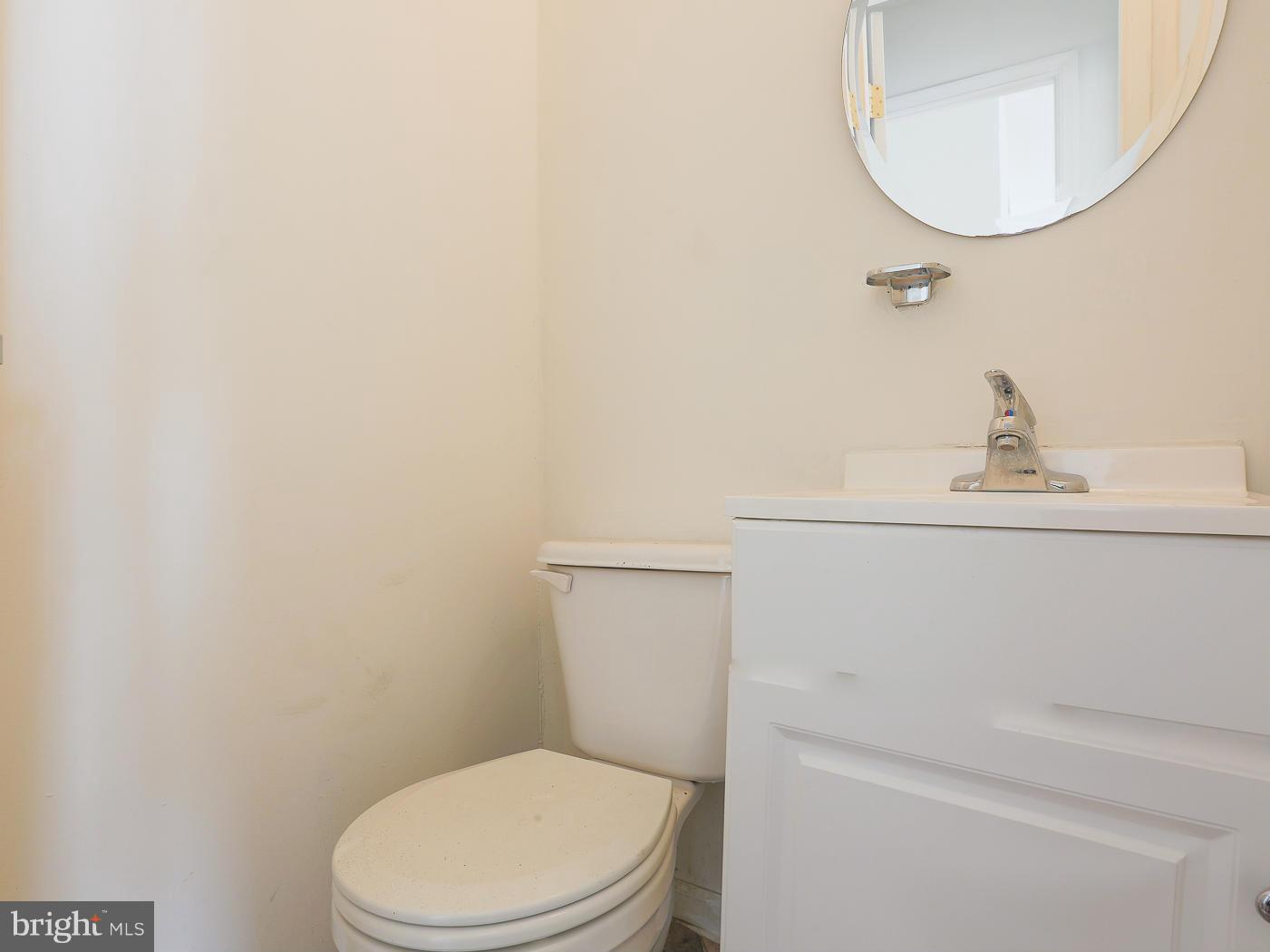 3114 Fairview Road Baltimore, MD 21207 - Photo 19 of 30 a white toilet sitting next to a bathroom sink