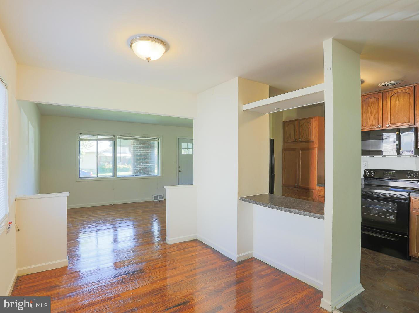3114 Fairview Road Baltimore, MD 21207 - Photo 3 of 30 a view of empty room with wooden floor and fan