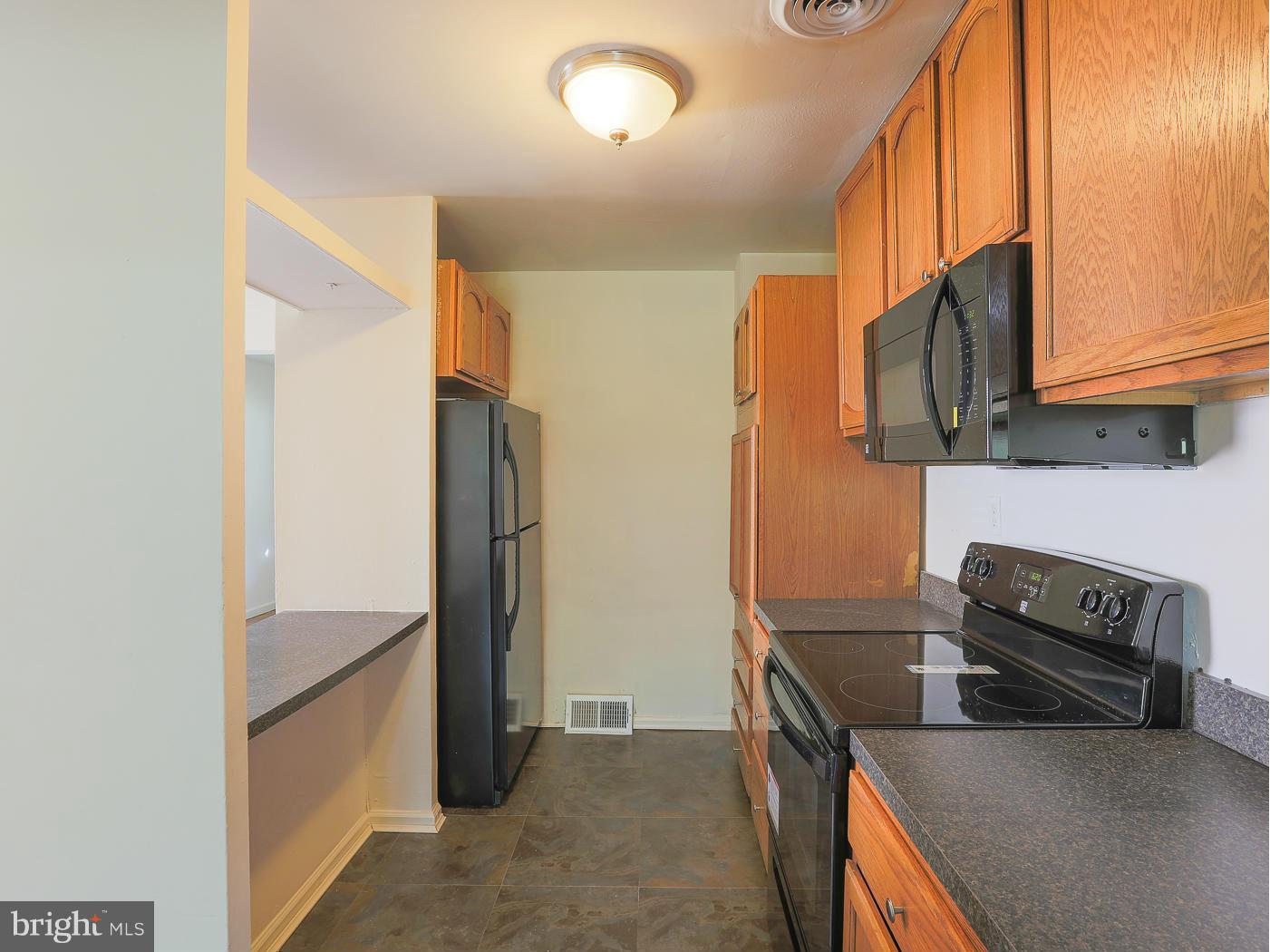 3114 Fairview Road Baltimore, MD 21207 - Photo 5 of 30 a kitchen with a refrigerator and a stove