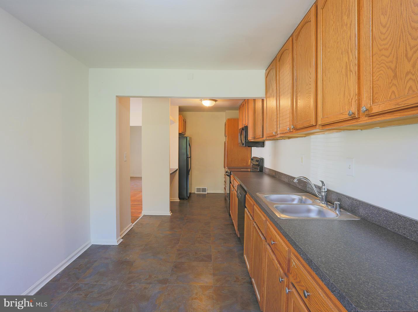 3114 Fairview Road Baltimore, MD 21207 - Photo 7 of 30 a kitchen with a sink and cabinets