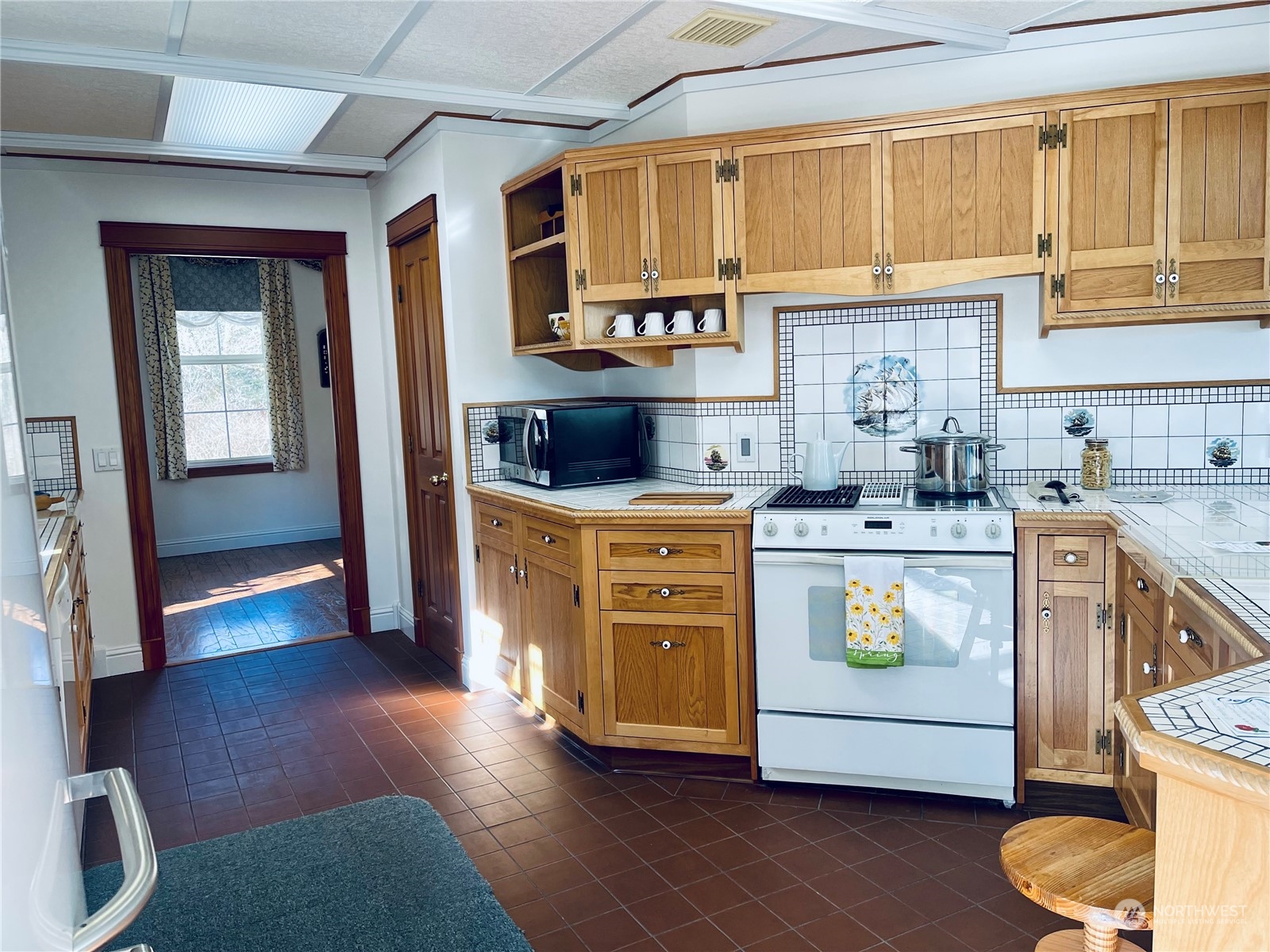 36808 Stackpole Road Oysterville, WA 98641 - Photo 11 of 40 a kitchen with a stove a sink a refrigerator and cabinets