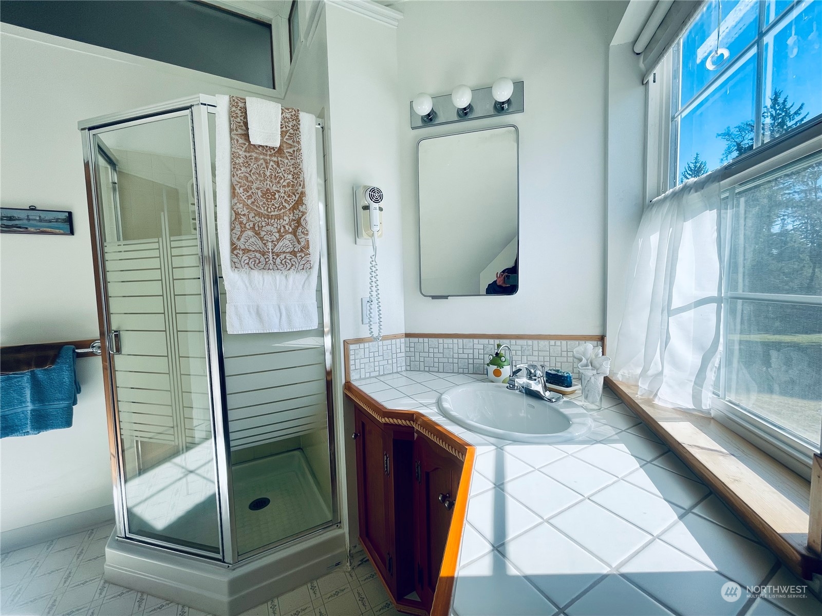 36808 Stackpole Road Oysterville, WA 98641 - Photo 32 of 40 a bathroom with a sink and a mirror