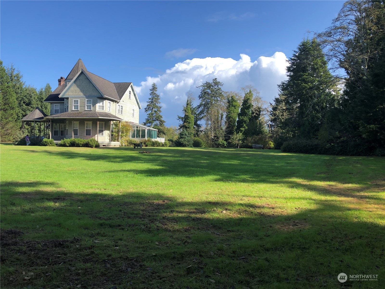 36808 Stackpole Road Oysterville, WA 98641 - Photo 5 of 40 a view of a green field with house in the background