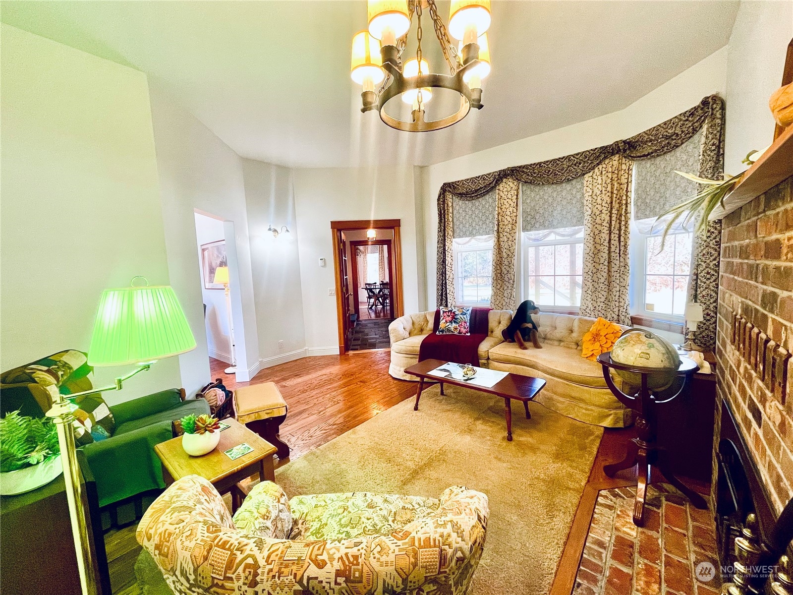 36808 Stackpole Road Oysterville, WA 98641 - Photo 8 of 40 a bed room with large bed and a chandelier