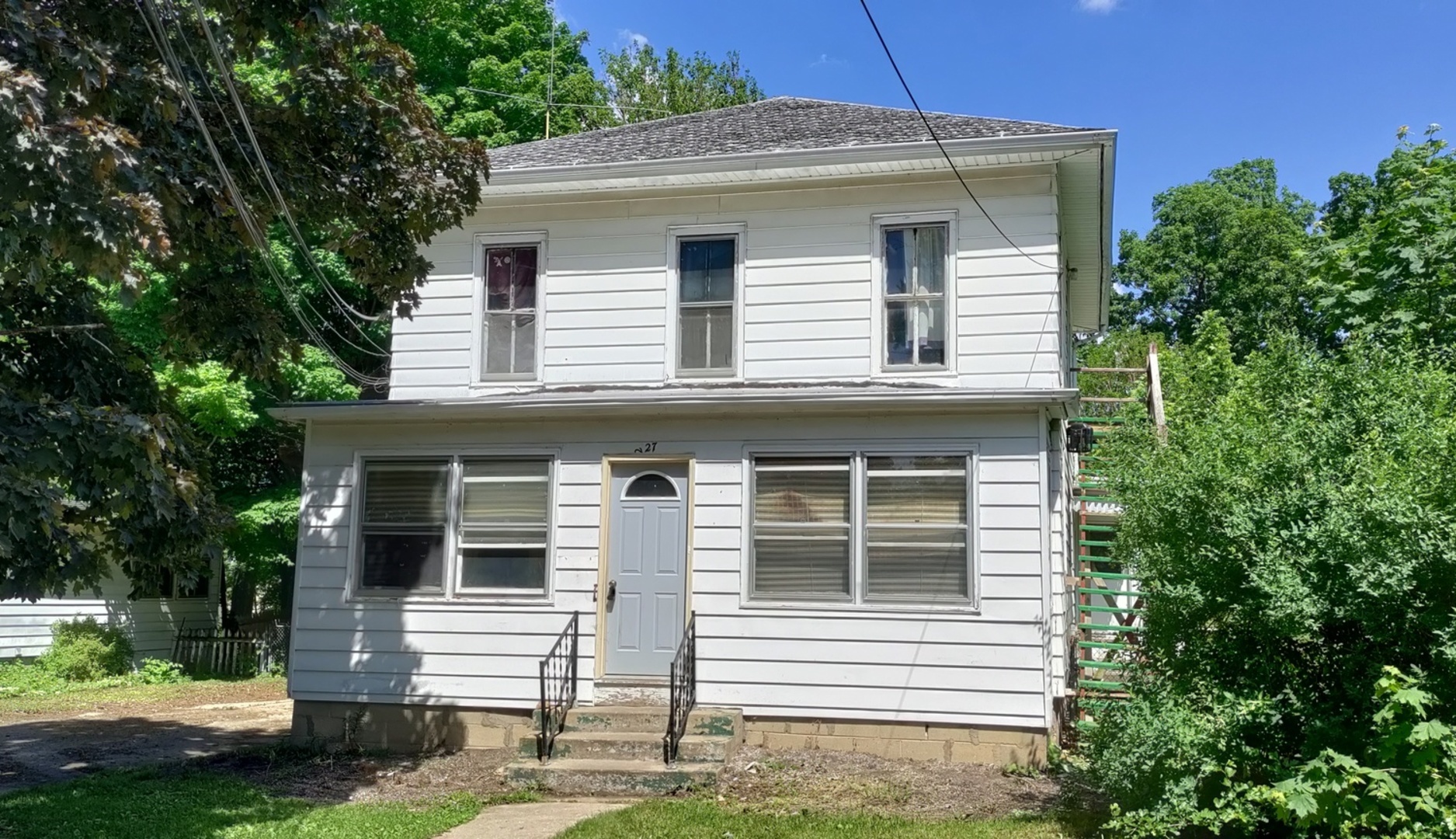 227 Ave C Rochelle, IL 61068 - Photo 1 of 36 a front view of a house with a yard