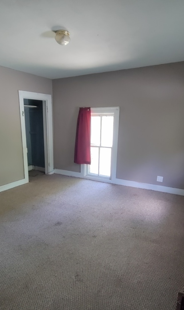 227 Ave C Rochelle, IL 61068 - Photo 20 of 36 a view of empty room with window