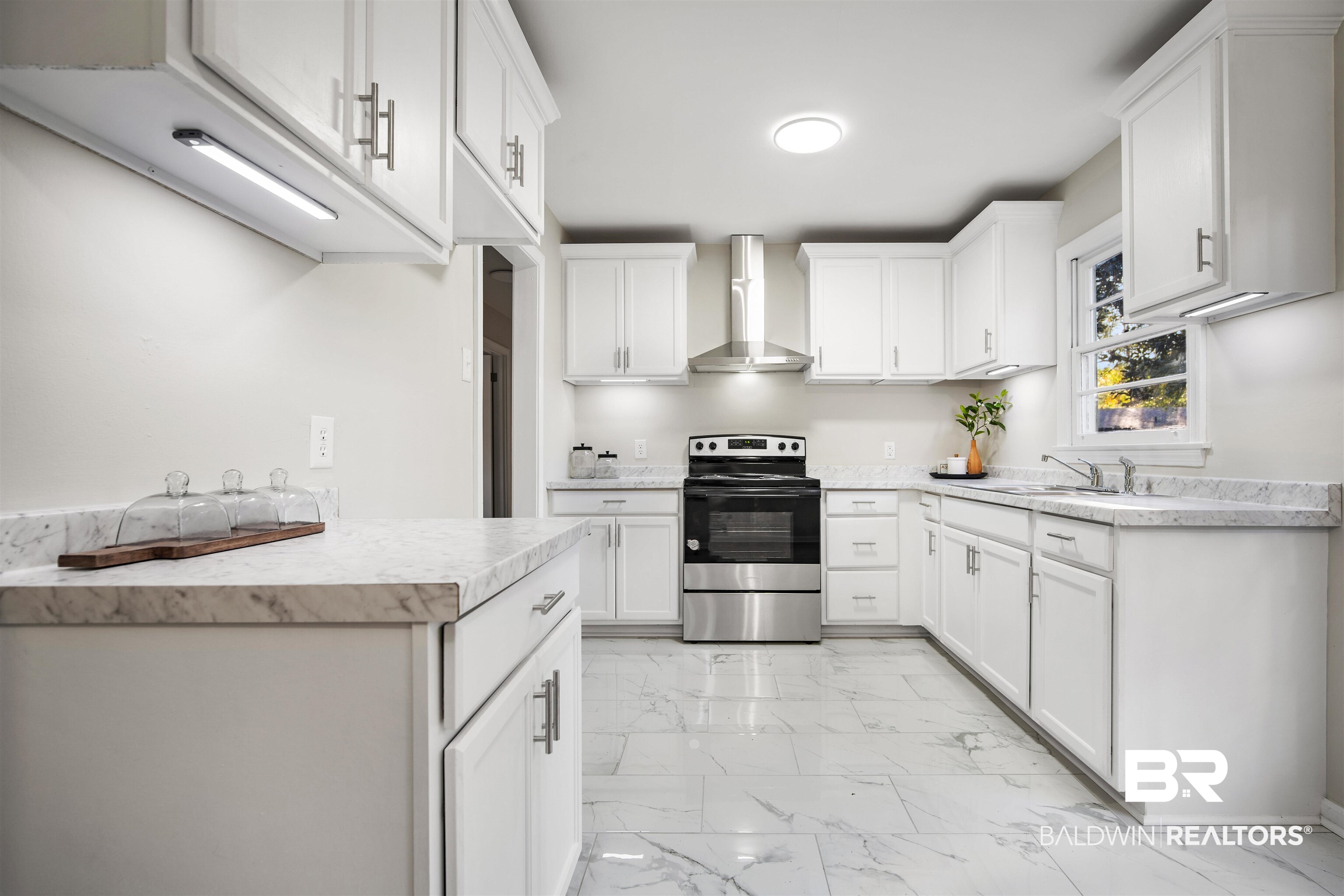662 Merritt Drive Mobile, AL 36609 - Photo 10 of 21 Kitchen featuring white cabinetry, electric range, sink, and wall chimney range hood