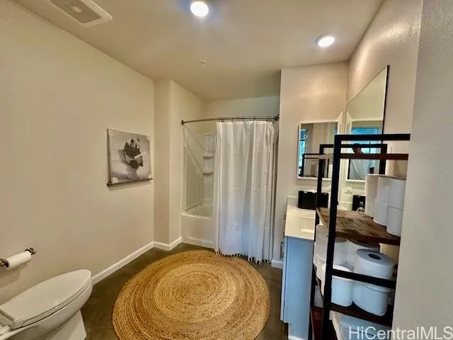 a bathroom with a granite countertop toilet sink and shower