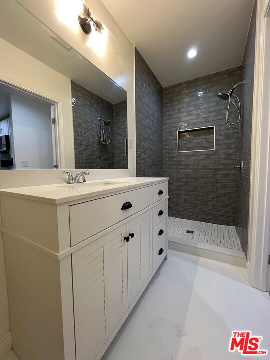 1530 5th Avenue Los Angeles, CA 90019 - Photo 4 of 9 a bathroom with a sink a shower and a mirror