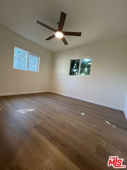 1530 5th Avenue Los Angeles, CA 90019 - Photo 7 of 9 an empty room with wooden floor and windows
