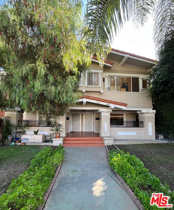 1530 5th Avenue Los Angeles, CA 90019 - Photo 9 of 9 a front view of a house with a garden and trees