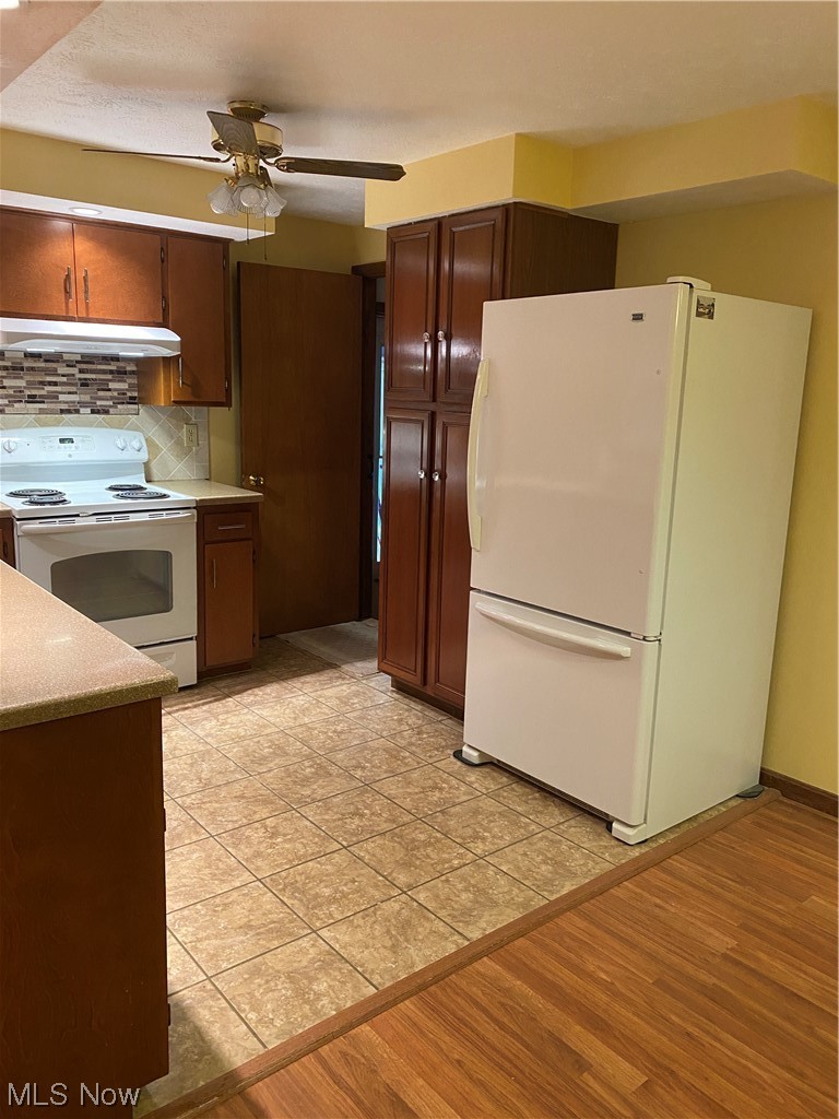 1518 Walnut Road Southwest Massillon, OH 44647 - Photo 3 of 26 Kitchen with extractor fan, stove, ceiling fan, fridge, and tasteful backsplash
