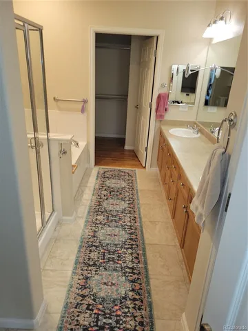 a bathroom with a sink a toilet a mirror a shower and vanity