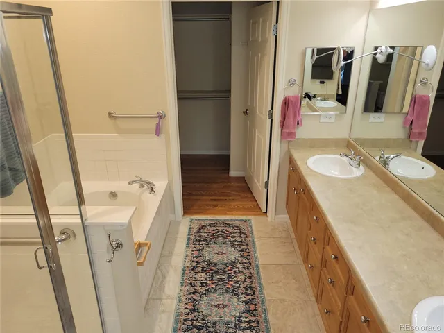 a bathroom with a sink a mirror and shower