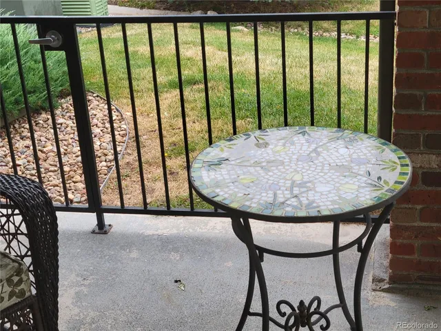 a view of staircase with a table and chair