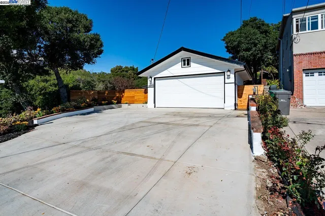 a view of garage and wooden fence