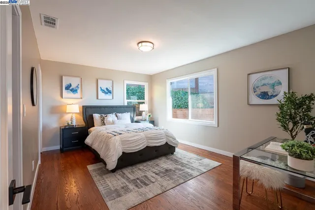 a bathroom with a granite countertop sink mirror vanity and toilet