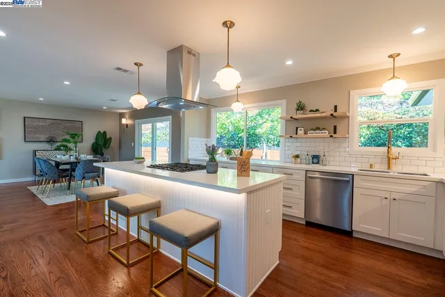 a kitchen with counter space dining table and chairs
