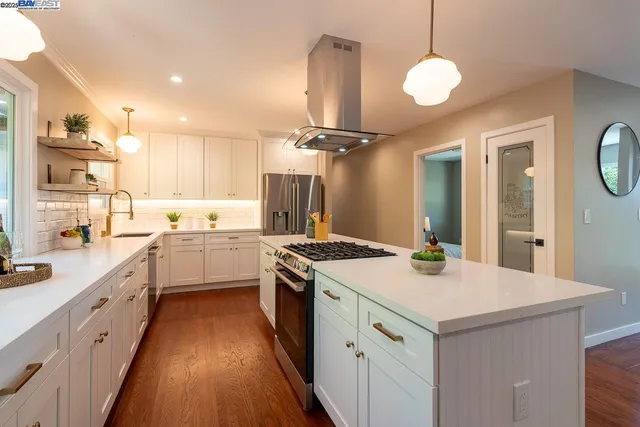 a kitchen with a sink appliances and cabinets
