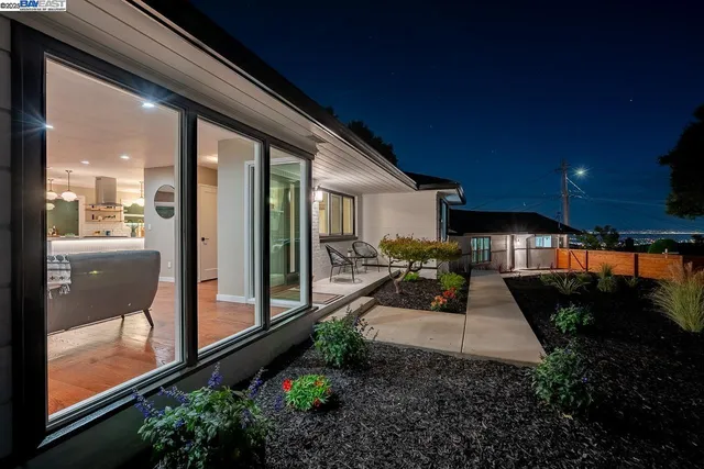 a view of a patio with couches table and chairs and potted plants