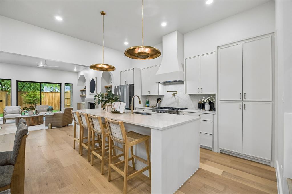 4615 Rusk Avenue Dallas, TX 75204 - Photo 6 of 25 a kitchen with stainless steel appliances a stove a sink a center island and cabinets