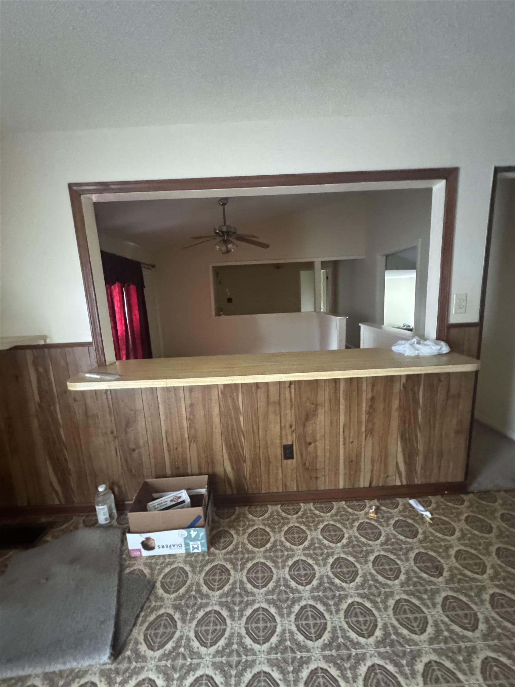 106 Cole Road Drummonds, TN 38023 - Photo 16 of 21 Pass-through window with wood-finish trim, wood-paneled half-wall, and a light-toned countertop