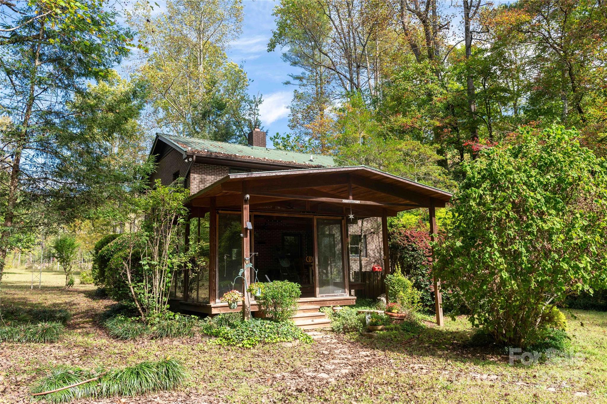 a view of a chair and table in backyard of the house