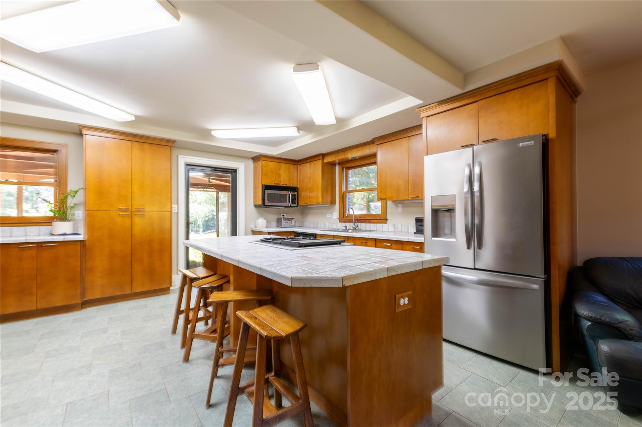 7825 Buck Creek Road Marion, NC 28752 - Photo 12 of 48 a kitchen with stainless steel appliances granite countertop a refrigerator and a stove top oven