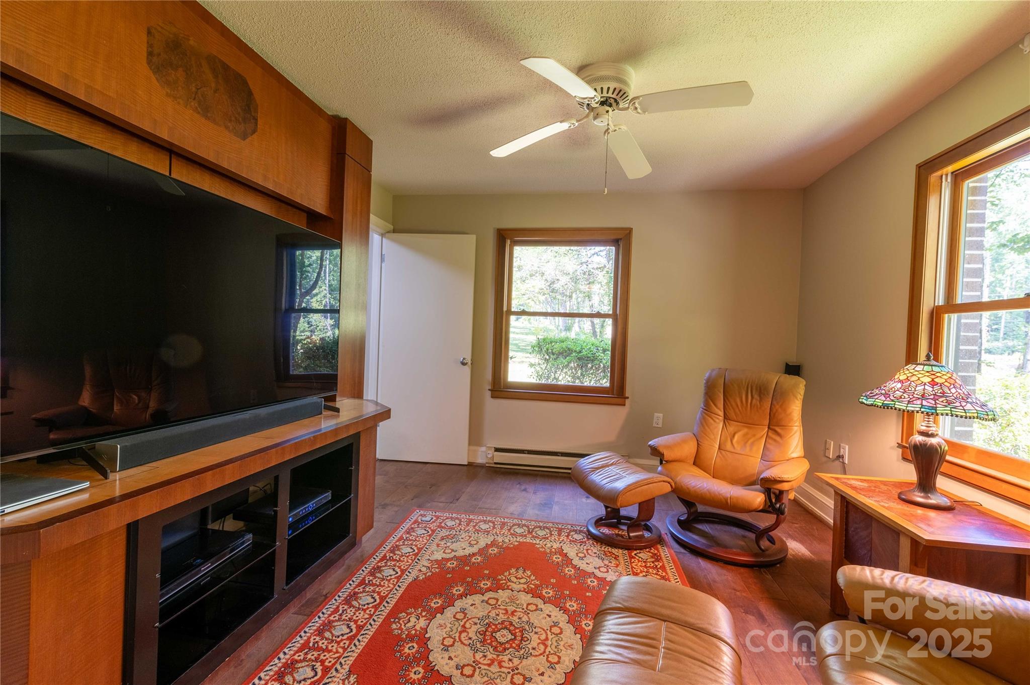 7825 Buck Creek Road Marion, NC 28752 - Photo 16 of 48 a living room with furniture a flat screen tv and a window