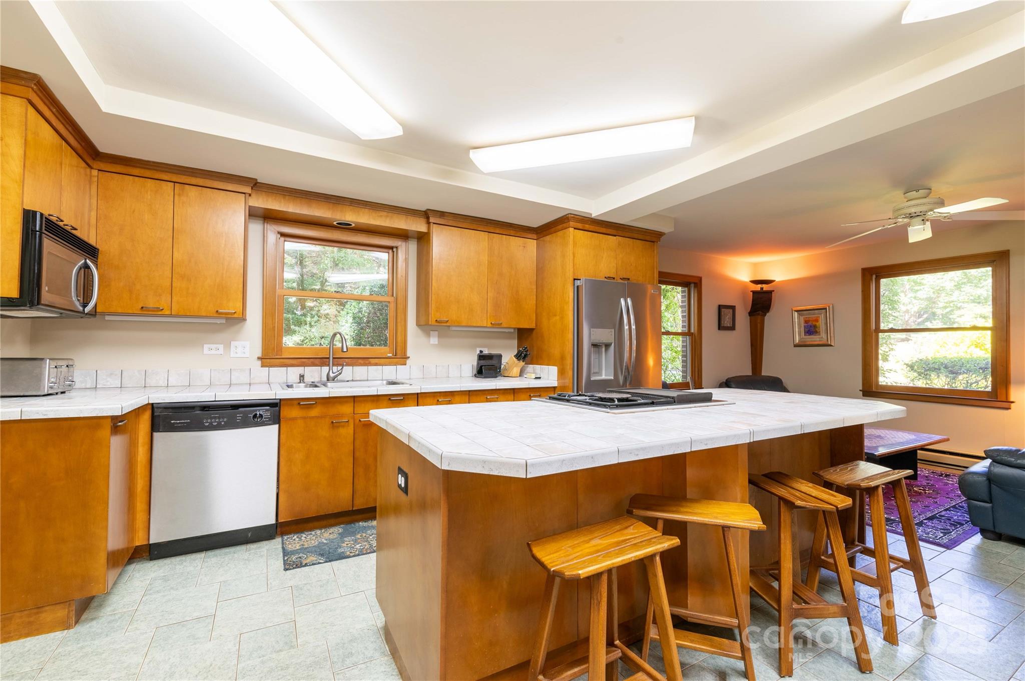 7825 Buck Creek Road Marion, NC 28752 - Photo 9 of 48 a kitchen with stainless steel appliances granite countertop table chairs sink and window