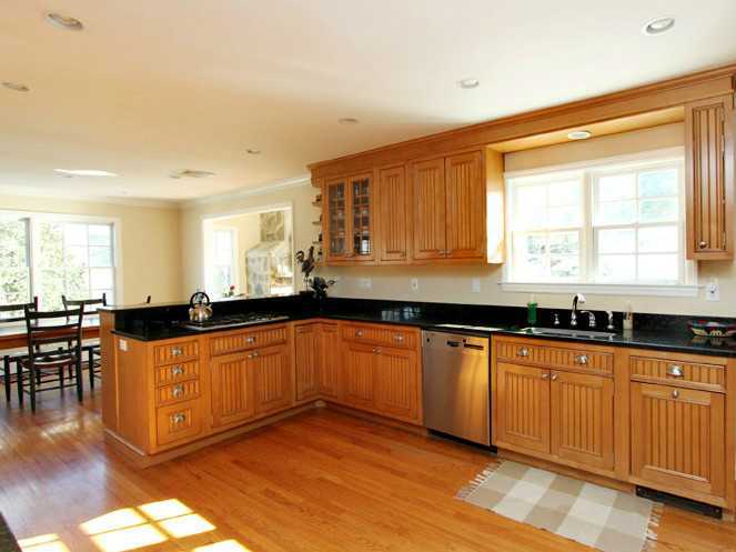 152 Lockwood Road Riverside, CT 06878 - Photo 4 of 12 a large kitchen with stainless steel appliances granite countertop a sink and cabinets