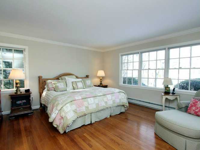 152 Lockwood Road Riverside, CT 06878 - Photo 6 of 12 a bedroom with a bed and wooden floor
