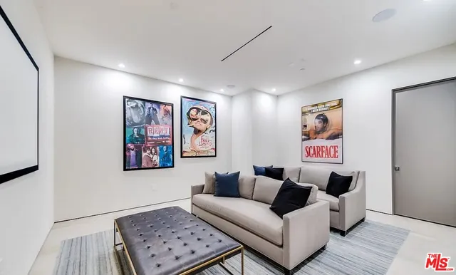 a living room with furniture and a wall painting