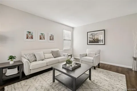 a living room with furniture a rug and a window