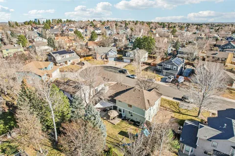 a front view of a house with garden and trees
