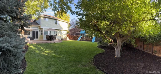 a view of a house with a yard porch and sitting area