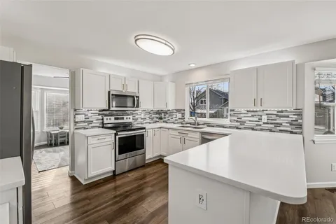 a kitchen with a stove a sink and a refrigerator
