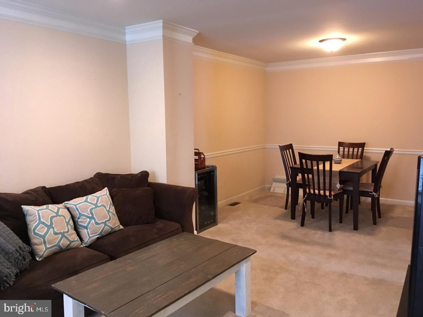 233 Flagstone Road, Unit 5 Chester Springs, PA 19425 - Photo 5 of 12 a living room with furniture and a dining table
