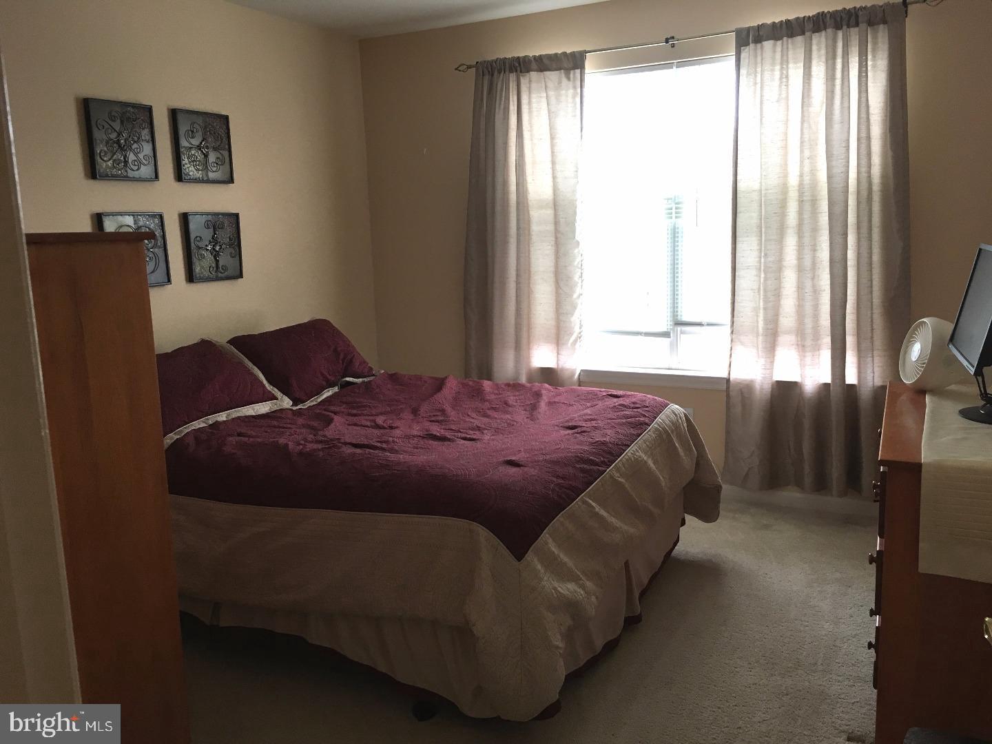 233 Flagstone Road, Unit 5 Chester Springs, PA 19425 - Photo 8 of 12 a bedroom with a bed and window