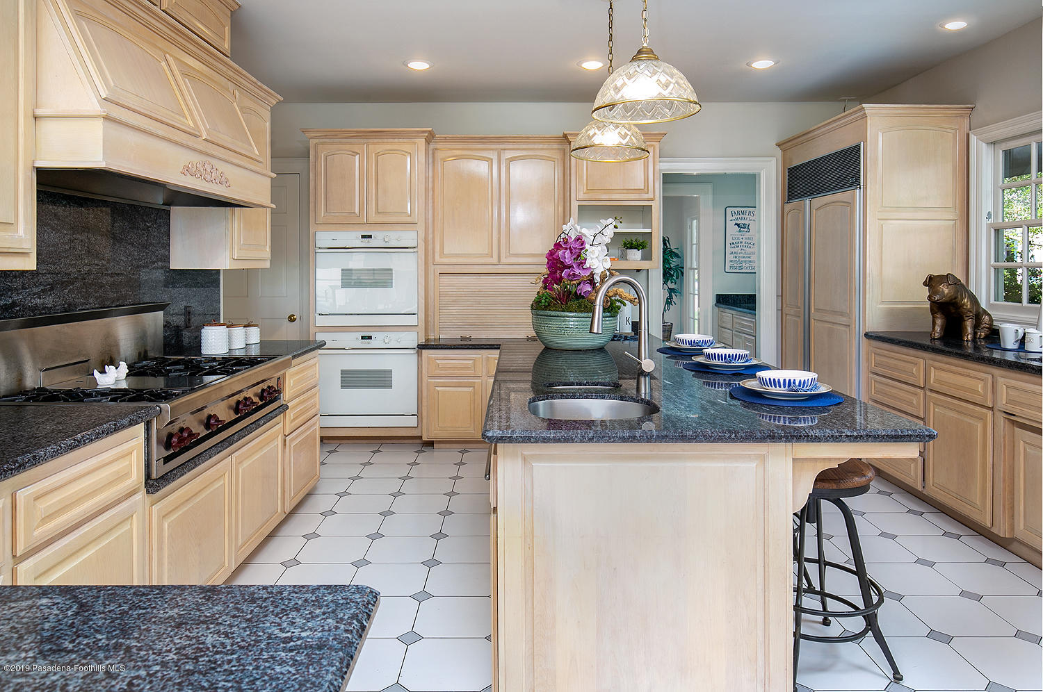820 Arden Road Pasadena, CA 91106 - Photo 16 of 75 a kitchen with granite countertop a sink cabinets stainless steel appliances and a center island