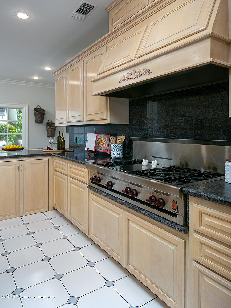 820 Arden Road Pasadena, CA 91106 - Photo 18 of 75 a kitchen with stainless steel appliances granite countertop a sink and a stove