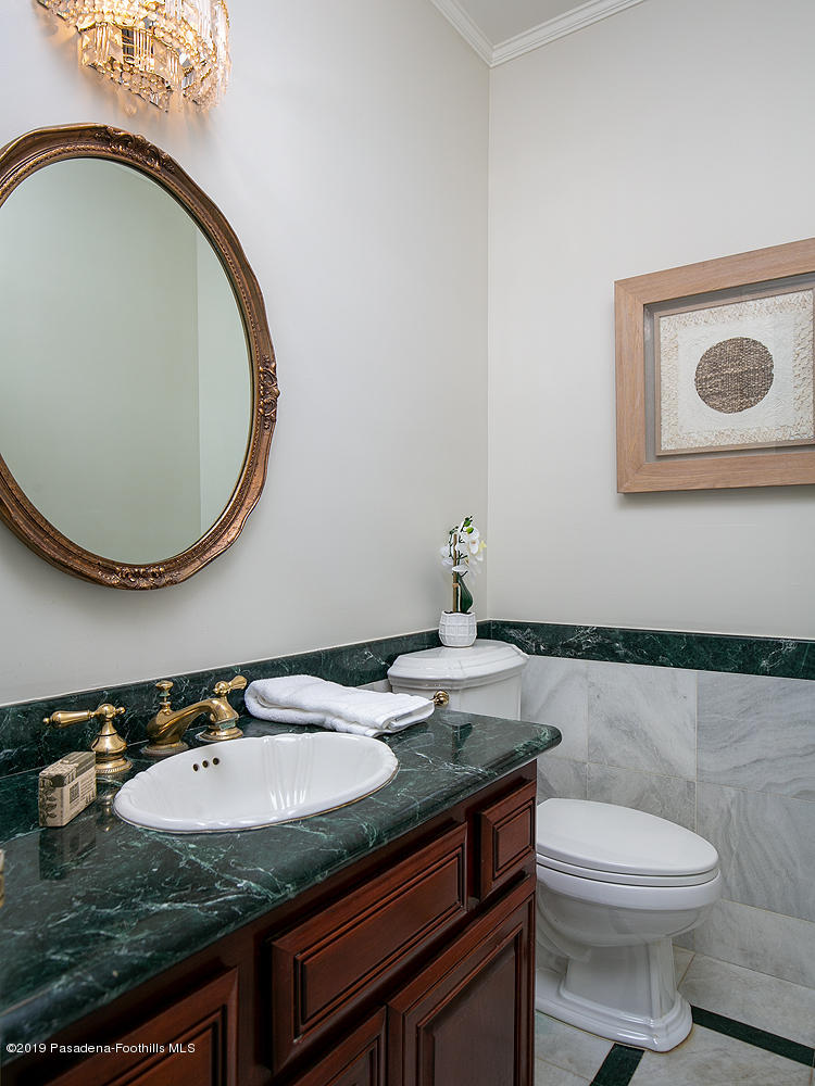 820 Arden Road Pasadena, CA 91106 - Photo 27 of 75 a bathroom with a granite countertop toilet sink and mirror