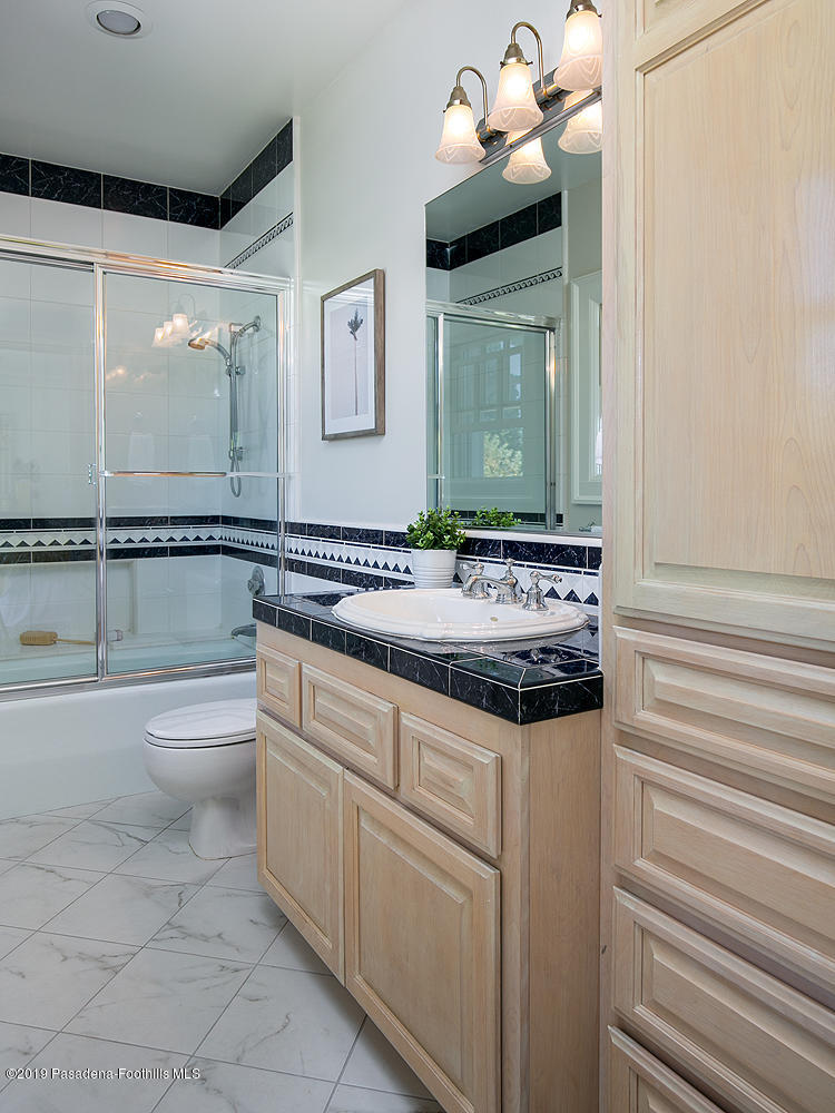 820 Arden Road Pasadena, CA 91106 - Photo 45 of 75 a bathroom with a granite countertop sink a toilet and mirror