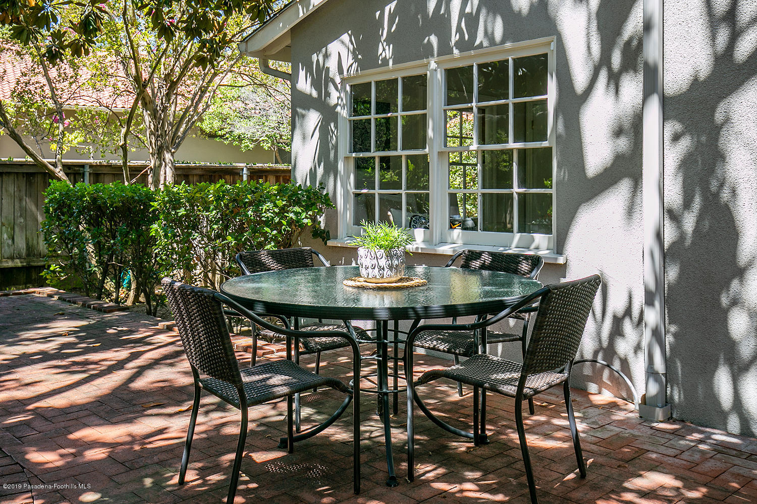 820 Arden Road Pasadena, CA 91106 - Photo 59 of 75 a view of an outside dining space with a table and chairs