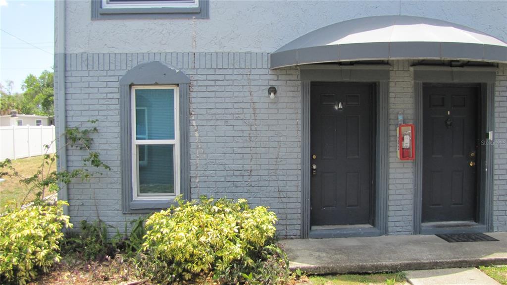 5116 East Temple Heights Road, Unit A Tampa, FL 33617 - Photo 2 of 14 a front view of a house with garden