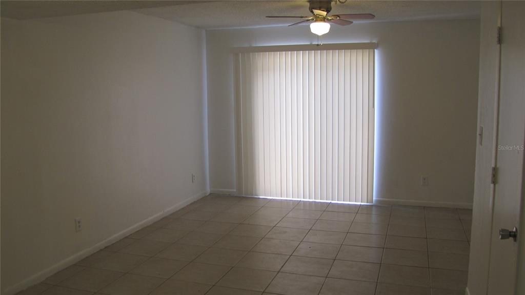 5116 East Temple Heights Road, Unit A Tampa, FL 33617 - Photo 3 of 14 a view of an empty room with a window